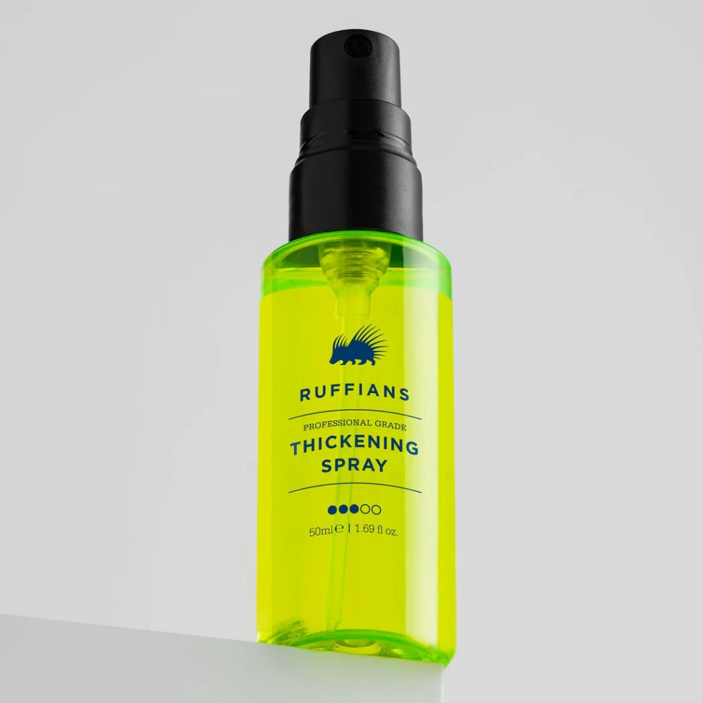 A bottle of Ruffians Professional Grade Thickening Spray with bright neon yellow-green liquid, a black spray pump, and a white label, set against a clean light gray background.