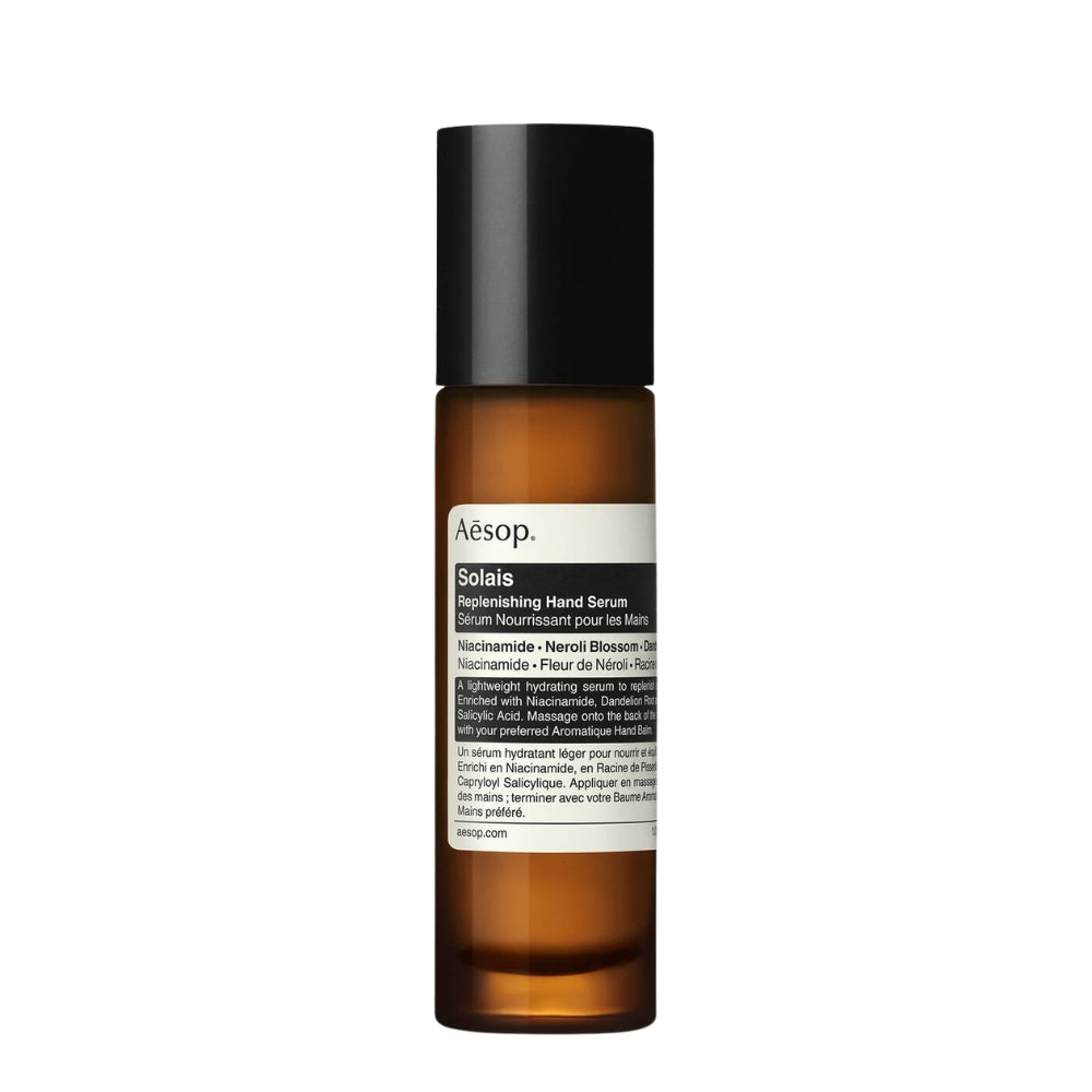 Aesop Solaris Replenishing Hand Serum in an amber glass bottle with a black cap and white label, centered on a plain white background.