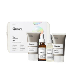 The Ordinary Renewal Set skincare collection including a white zippered case, a gray cleanser tube, a brown serum dropper bottle, a white toner bottle, and a white moisturizing cream tube, arranged on a white background.