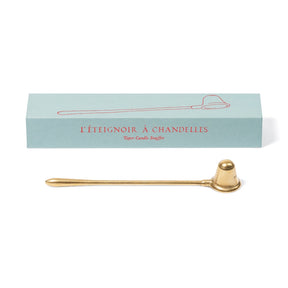 A brass taper candle snuffer with a polished gold finish, displayed below its light blue packaging box with red French text.